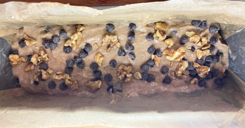 banana bread garnished with chocolate chips and walnuts