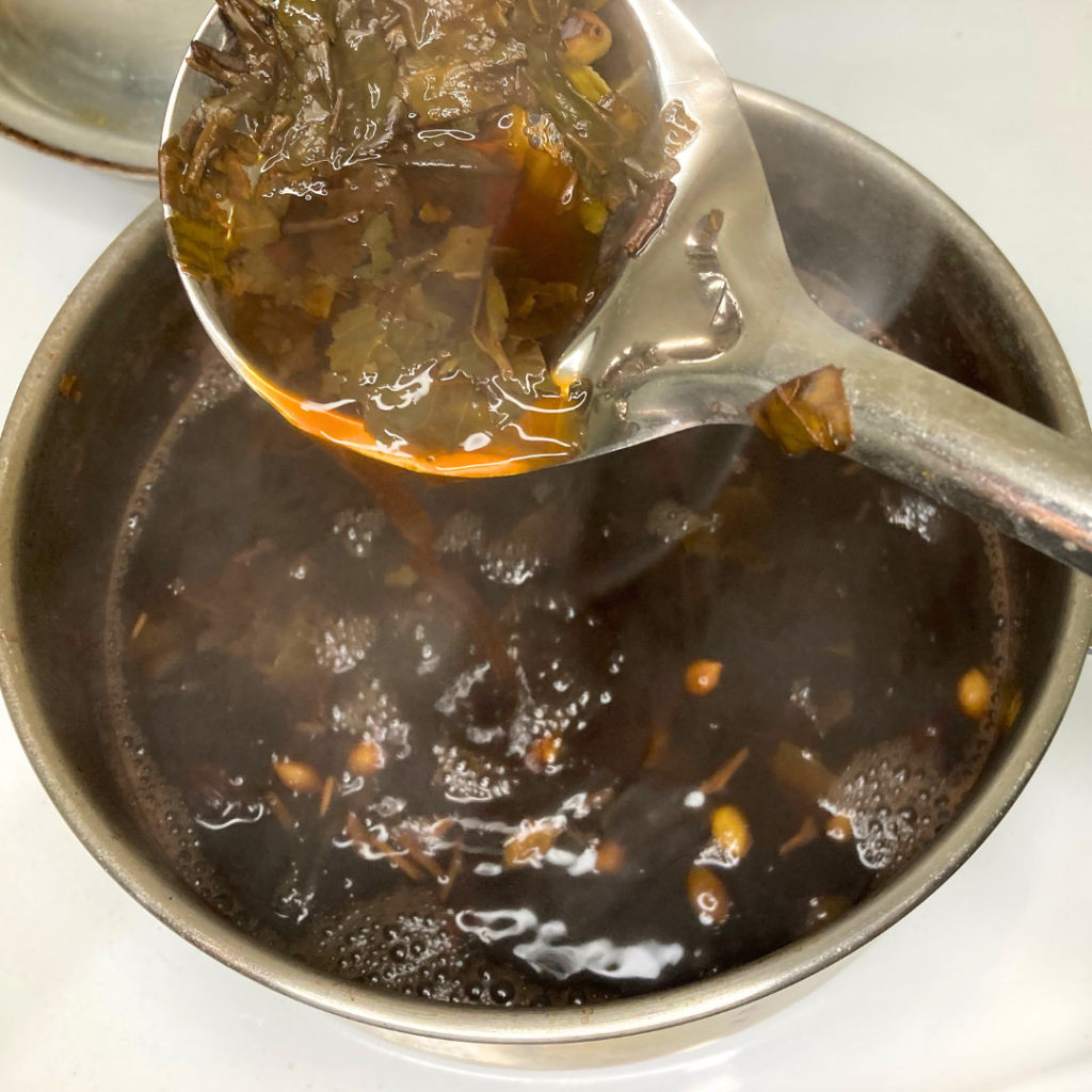 stirr pink tea in upword motion to release color.