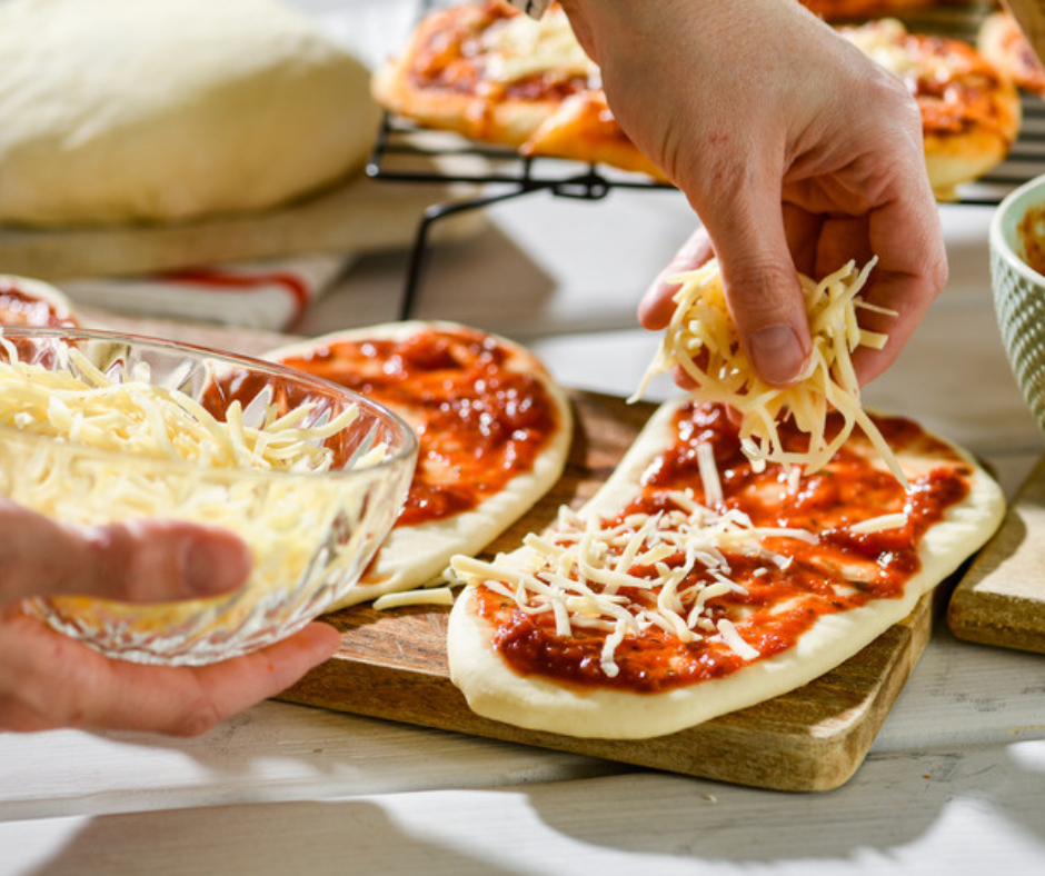 Spread the shredded mozzarella cheese on mini pizzas